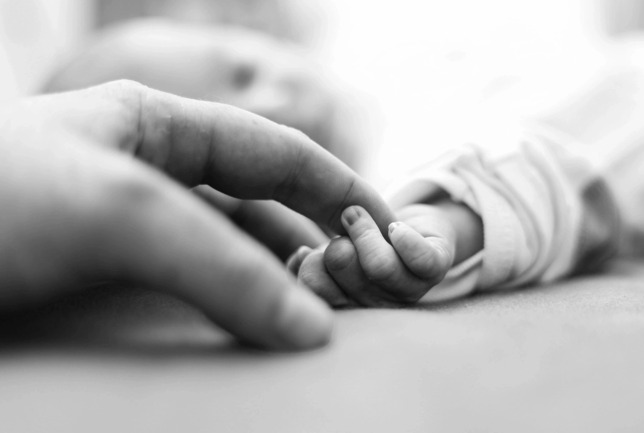 Parent and child holding hands representing challenges related to postpartum OCD
